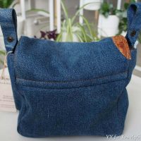 Classic blue denim cotton decorated with two pieces of brown leather imitating reptile skin.